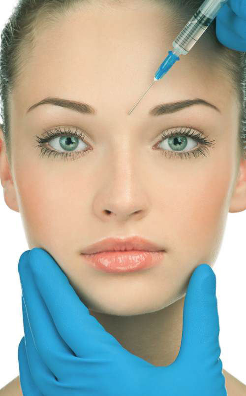 young woman receiving botulinum toxin (Botox/Xeomin) injection between eyebrows