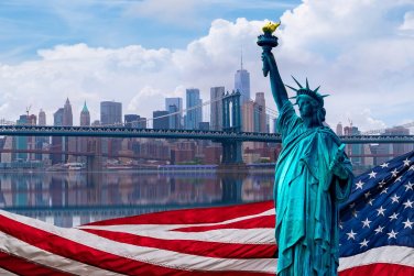 Statue of Liberty with American flag and New York City