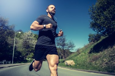man running for fitness in park.