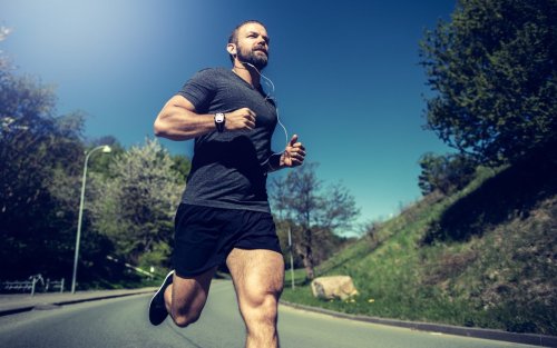 man running for fitness in park.